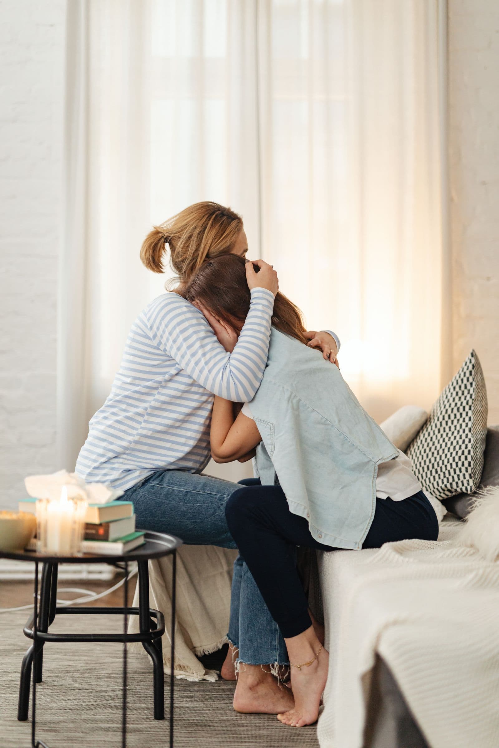 A mother and daughter sharing a warm embrace at home