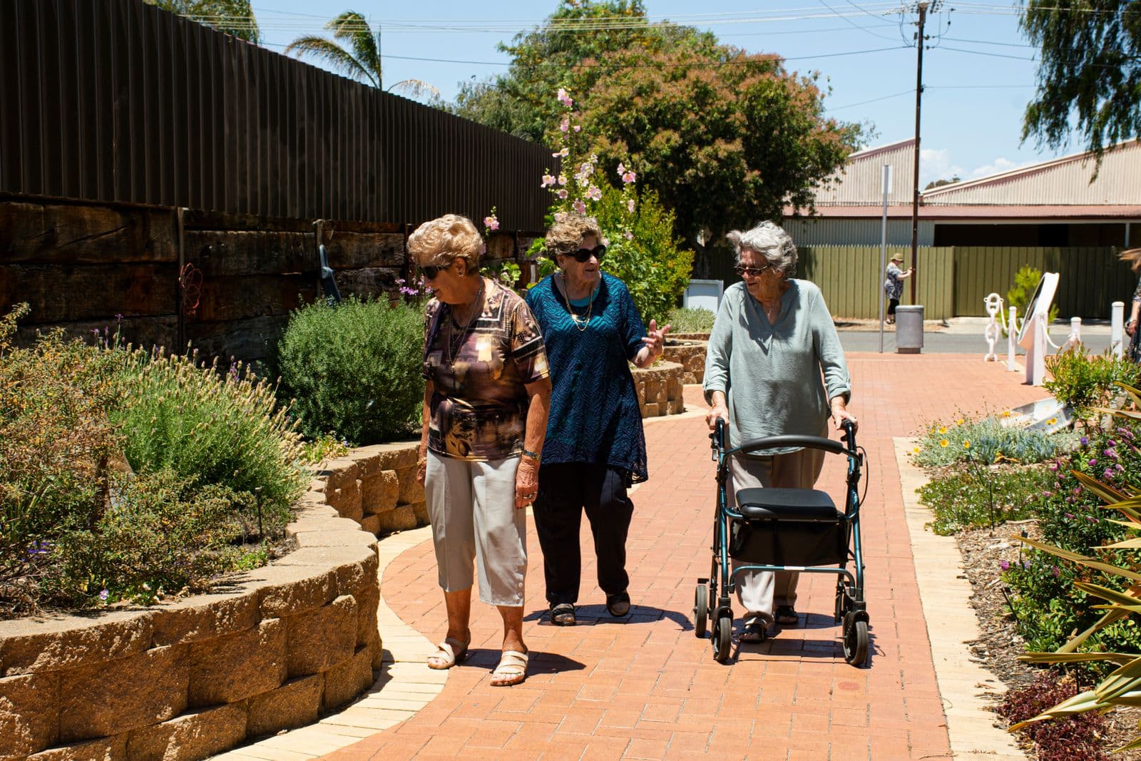 A small group of senior women enjoying a leisurely walk together outdoors