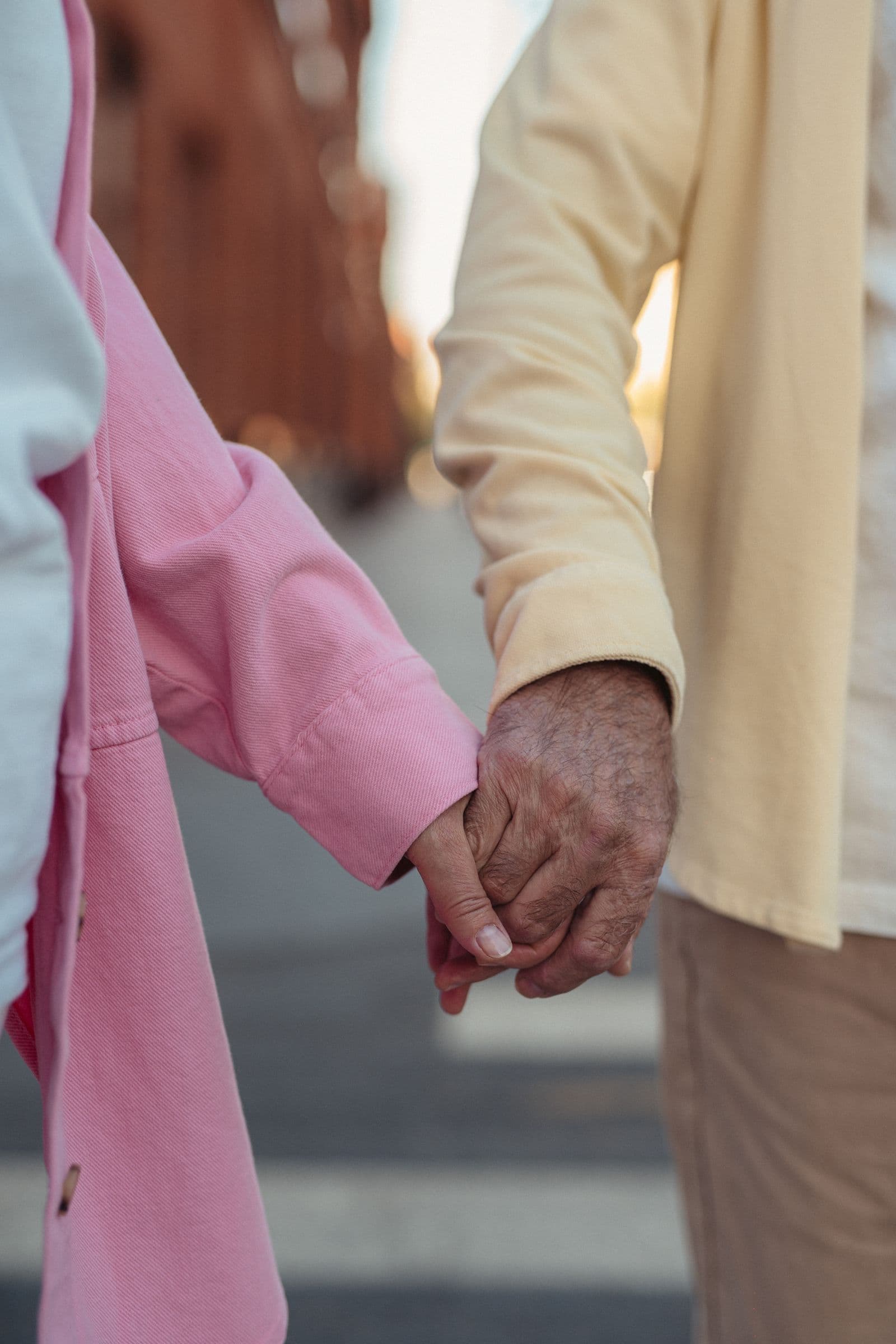 An elderly couple's hands joined together, representing the dignity and trust of personal care